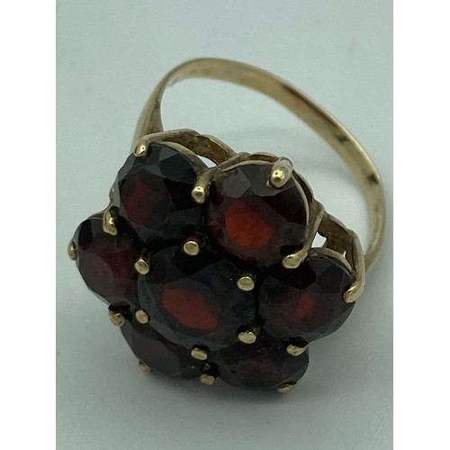 140 - 9 carat GOLD,GARNET CLUSTER RING , having seven large Garnets set to top.Full UK hallmark. Complete ... 