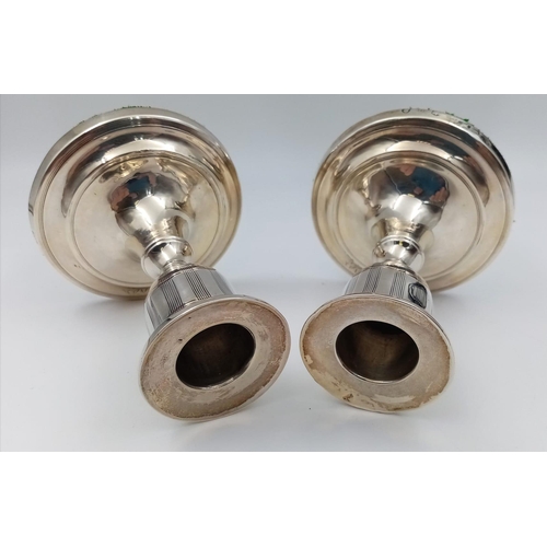 1073 - A pair of Georgian Solid Silver Candle Holders of an unusual size.  10.5cm in height and weighs 393.... 