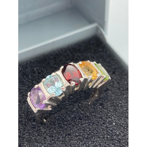 357 - SILVER RING with multi stones set to top in the colours of Amethyst, Aqua, Garnet ,Topaz and Peridot... 