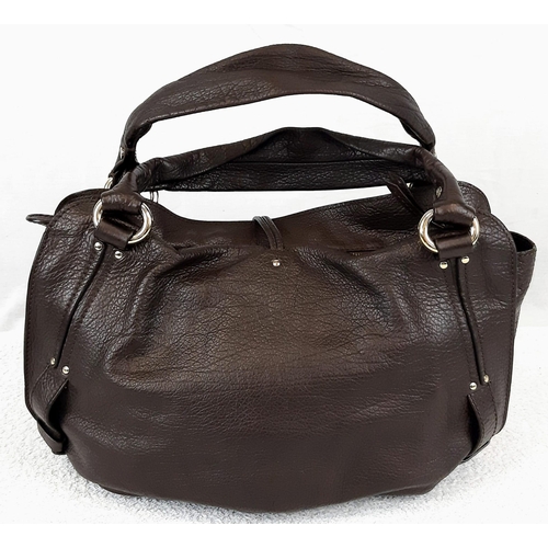 706 - A Brown Leather Celine Handbag. Classic double handle with gilded hoops. Celine tassel decoration. M... 