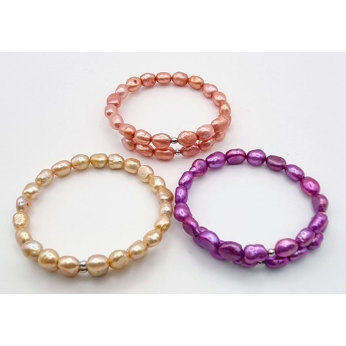 1138 - A Trio of Different Coloured Cultured Freshwater Pearl Expandable Bangles.