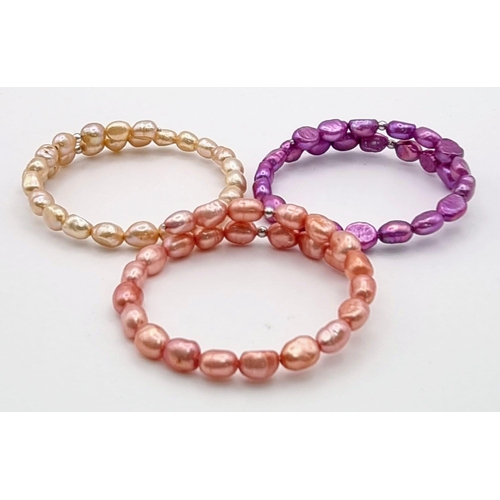 1138 - A Trio of Different Coloured Cultured Freshwater Pearl Expandable Bangles.