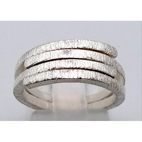 1099 - 4 LADIES SILVER FASHION RINGS.  20.3gms