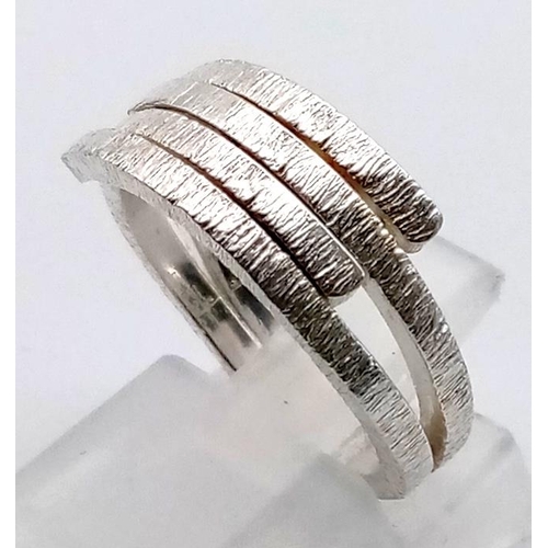 1099 - 4 LADIES SILVER FASHION RINGS.  20.3gms