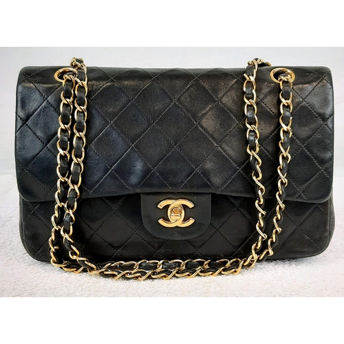 144 - A Medium Classic Double Chanel Flap Bag. Black lambskin leather with 24K gold plated hardware. Burgu... 