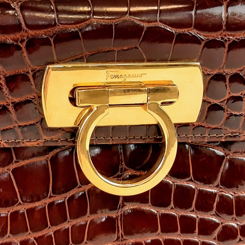 257 - An Italian Salvatore Ferragamo Crocodile Bag. Finished in chocolate brown with gilded touches and a ... 