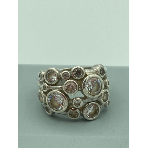 628 - SiLVER multi clear stone RING having openwork  work shoulders and gemstones set to top with markings... 