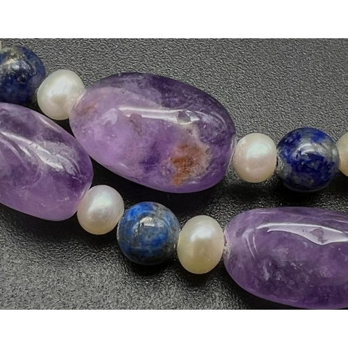 952 - A Cultured Freshwater Pearl, Amethyst and Lapis Lazuli Hand-made Necklace. 925 silver clasp. 44cm