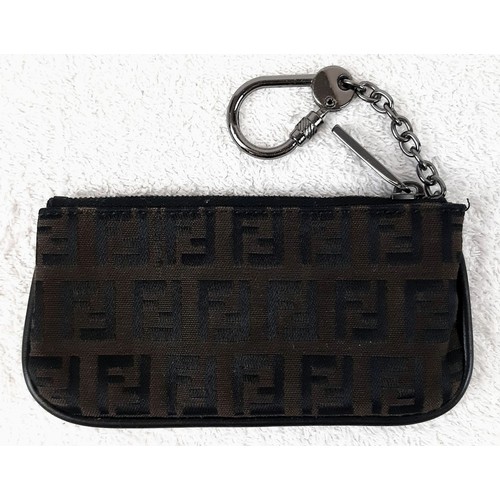 713 - A Fendi Monogrammed Brown Key Chain Pouch. Canvas and leather with a Fendi key chain attached. In go... 