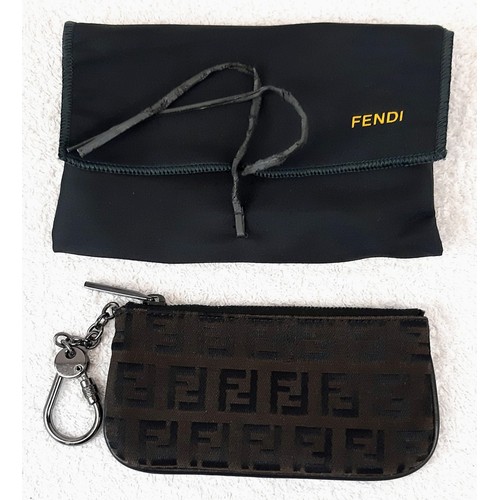 713 - A Fendi Monogrammed Brown Key Chain Pouch. Canvas and leather with a Fendi key chain attached. In go... 