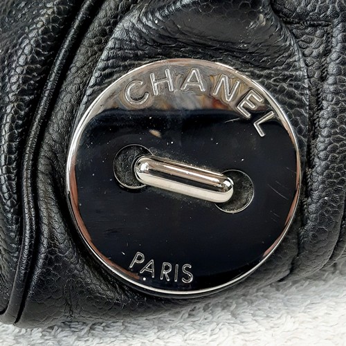 325 - A Chanel Caviar Leather Black Mini Handbag. Twin exterior pockets - silver toned hardware. Monogramm... 