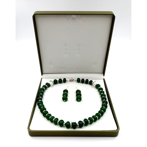 105 - A stylish emerald and cubic zirconia necklace and earrings set in a presentation box. Necklace lengt... 