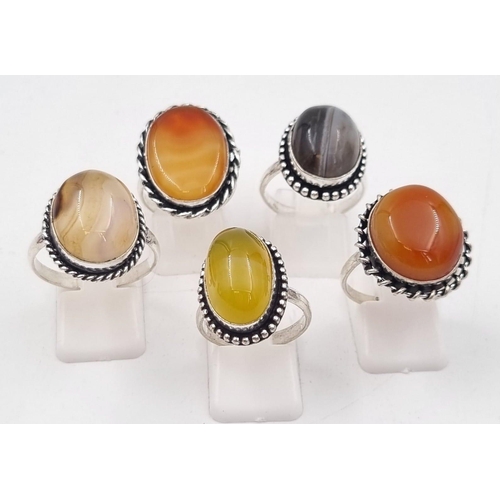 238 - Five white metal (untested) Botswana Agate rings presented in rose shaped velvet boxes.
(Size: N,V,P... 