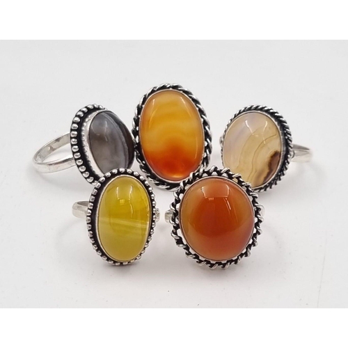 238 - Five white metal (untested) Botswana Agate rings presented in rose shaped velvet boxes.
(Size: N,V,P... 