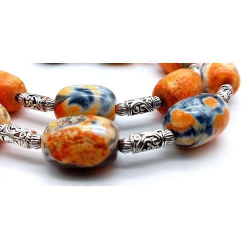 217 - A rarely seen and very collectable orange and black Namibian agate necklace and earrings set. Neckla... 