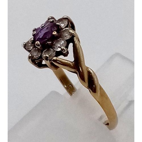 198 - A Vintage 9K Yellow Gold Amethyst and White Stone Ring. Central amethyst surrounded by a halo of whi... 