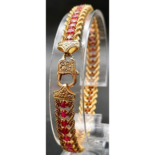 2 - An 18k Yellow Gold and Ruby Tennis Bracelet. Rope links either sider of 47 rubies. 17cm. 14.89g tota... 