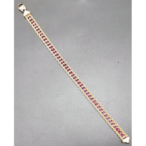 2 - An 18k Yellow Gold and Ruby Tennis Bracelet. Rope links either sider of 47 rubies. 17cm. 14.89g tota... 