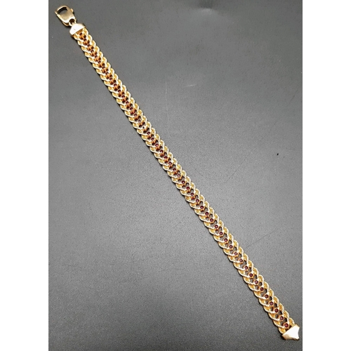 2 - An 18k Yellow Gold and Ruby Tennis Bracelet. Rope links either sider of 47 rubies. 17cm. 14.89g tota... 