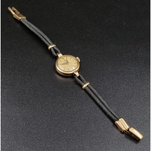 25 - A Vintage 9K Yellow Gold Ladies Omega Watch. 9K yellow Gold part-strap and case - 20mm. Gold dial. M... 