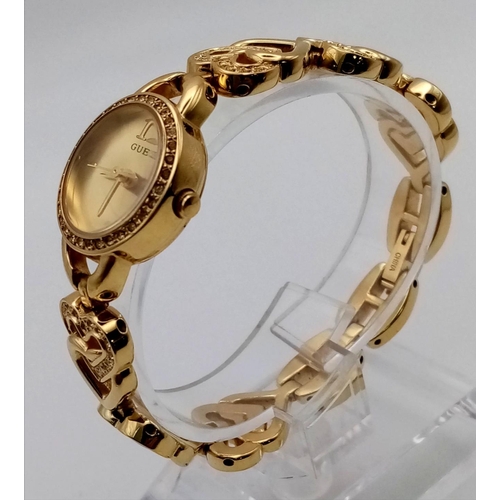 655 - A Guess Gold Plated Ladies Watch. Heart-shaped strap. Case - 20mm. White stone decoration throughout... 