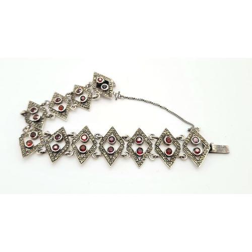 737 - STERLING SILVER FANCY GARNET SET BRACELET. 27G.
16CM