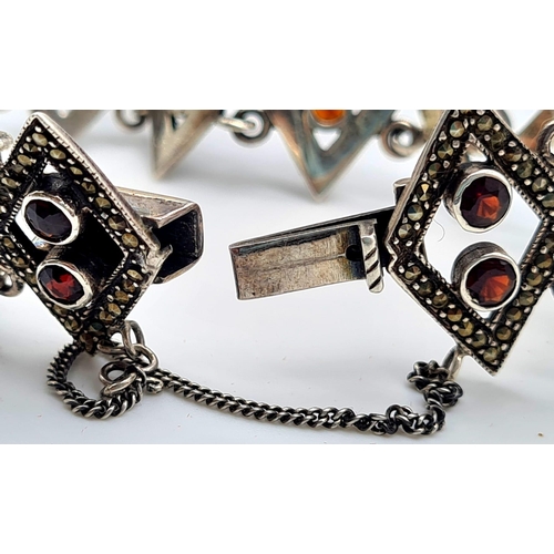 737 - STERLING SILVER FANCY GARNET SET BRACELET. 27G.
16CM