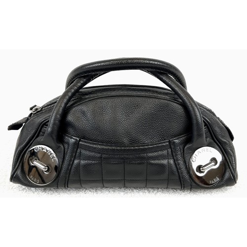 636 - A Chanel Caviar Leather Black Mini Handbag. Twin exterior pockets - silver toned hardware. Monogramm... 