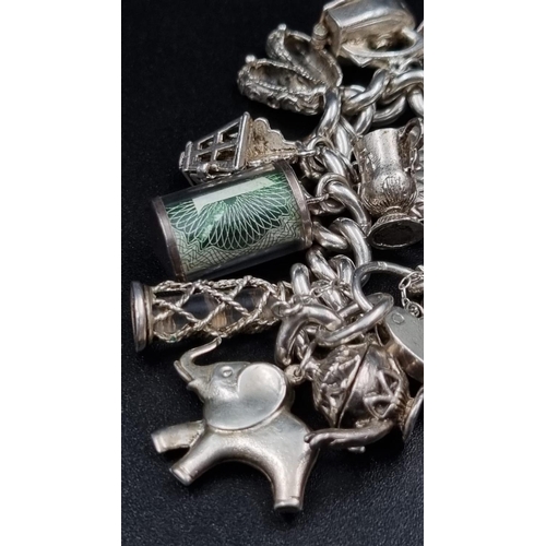 97 - A Wonderful Eclectic Silver Charm Bracelet. Some wonderful rare charms including a 10 shilling and 1... 