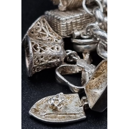 97 - A Wonderful Eclectic Silver Charm Bracelet. Some wonderful rare charms including a 10 shilling and 1... 