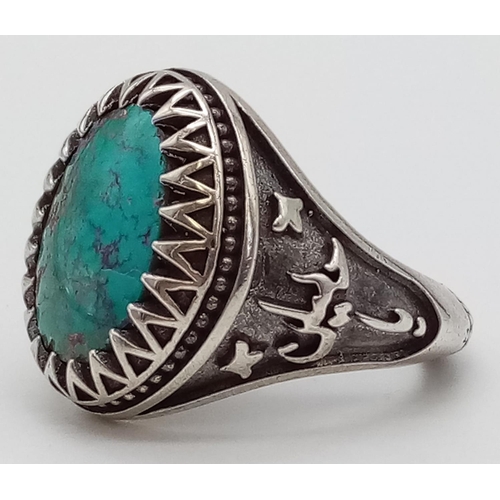 424 - A Vintage Natural Turquoise and Silver Ring. Large oval turquoise stone set in an Islamic silver set... 