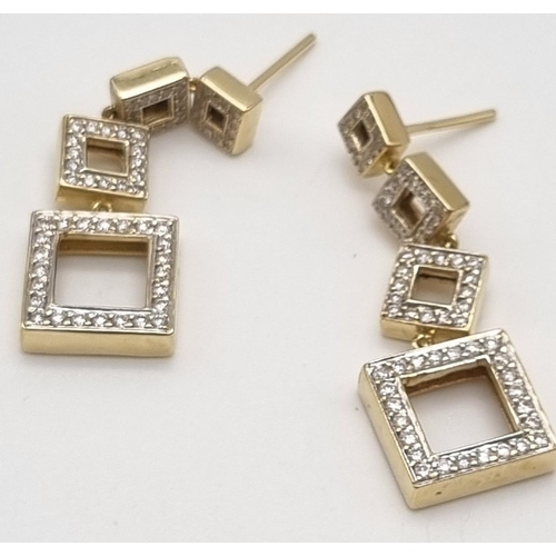 54 - A Pair of 18K Yellow Gold and Diamond Graduated Square Drop Earrings. 3.5cm drop. 2ct diamond weight... 