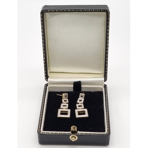 54 - A Pair of 18K Yellow Gold and Diamond Graduated Square Drop Earrings. 3.5cm drop. 2ct diamond weight... 