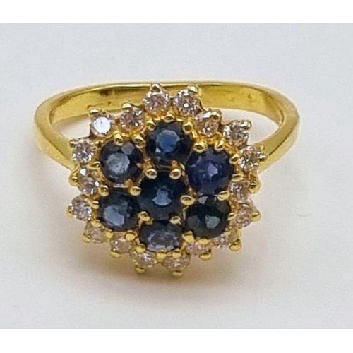 82 - A Gorgeous 18K Yellow Gold Sapphire and Diamond Ring. Seven clean sapphires surrounded by 18 small b... 