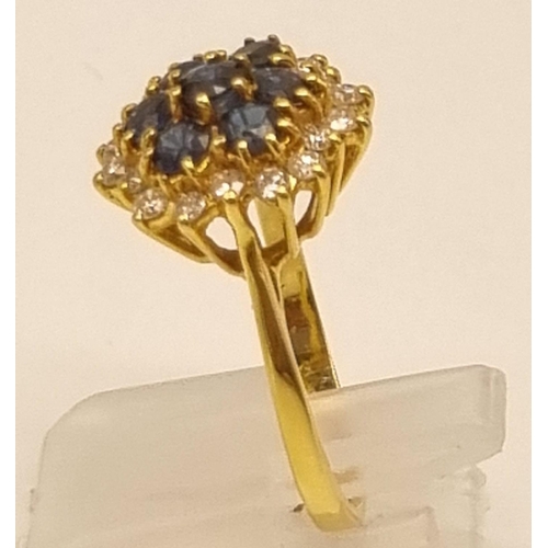 82 - A Gorgeous 18K Yellow Gold Sapphire and Diamond Ring. Seven clean sapphires surrounded by 18 small b... 