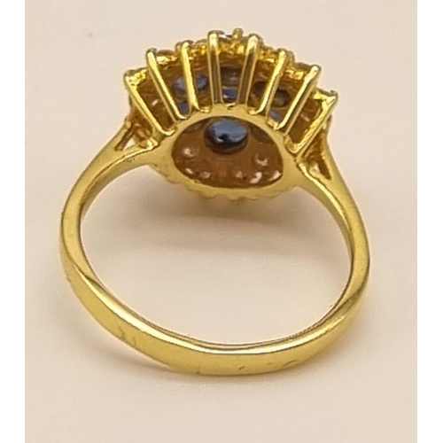 82 - A Gorgeous 18K Yellow Gold Sapphire and Diamond Ring. Seven clean sapphires surrounded by 18 small b... 