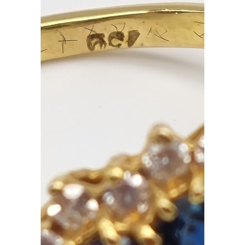 82 - A Gorgeous 18K Yellow Gold Sapphire and Diamond Ring. Seven clean sapphires surrounded by 18 small b... 