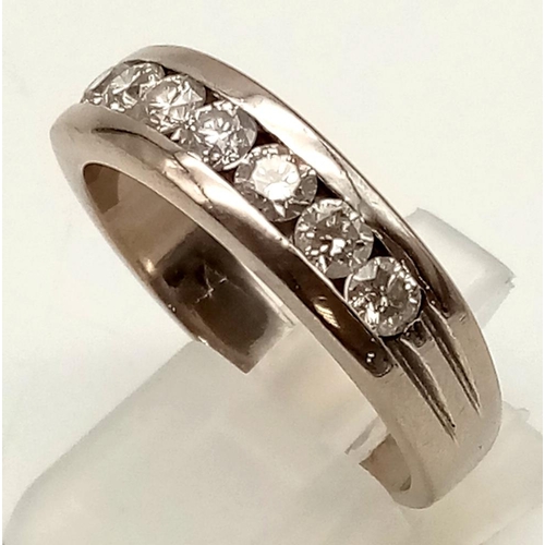 16 - An 18K White Gold (tested) Seven Diamond Channel Gents Dress Ring. 1.5ct bright diamonds. Size U 1/2... 