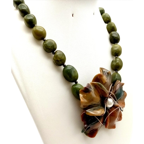 353 - A Vintage Natural Nephrite Jade Necklace. Beads with a large floral centre-piece.  42cm. 110g total ... 