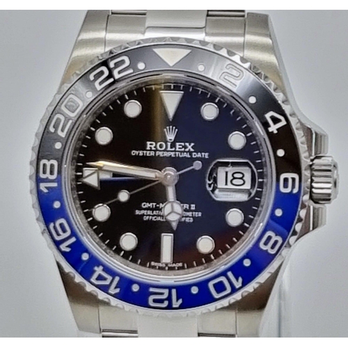 11 - A gents ROLEX GMT MASTER II. 42 mm dial with black face and blue bezel. In excellent/unused conditio... 