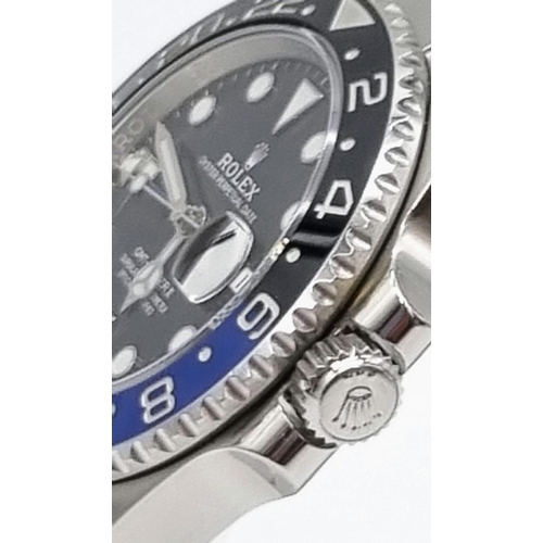 11 - A gents ROLEX GMT MASTER II. 42 mm dial with black face and blue bezel. In excellent/unused conditio... 