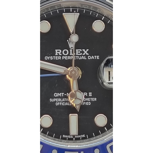 11 - A gents ROLEX GMT MASTER II. 42 mm dial with black face and blue bezel. In excellent/unused conditio... 