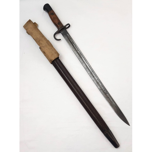 20 - 1907 Hooked Quillion Bayonet. Maker Enfield. Complete with early tear drop scabbard and frog.