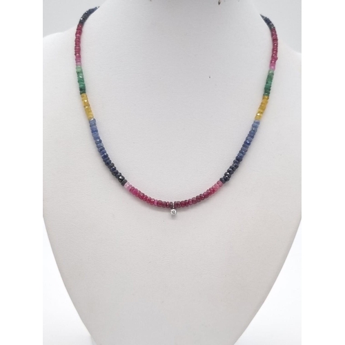 85 - A Natural Emerald, Ruby, Sapphire Gold and Diamond Necklace. Colourful beads with a small diamond mo... 