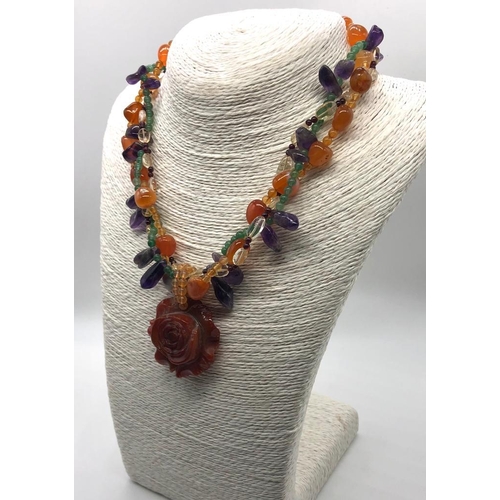 305 - A Natural Carved Carnelian Amethyst and Garnet Necklace. Large carnelian central flower with three r... 