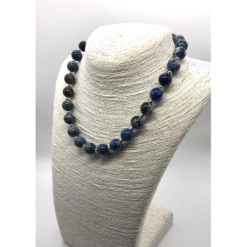 409 - A Blue Sea Sediment Jasper Beaded Necklace. 12mm beads. 40cm. T-bar clasp.