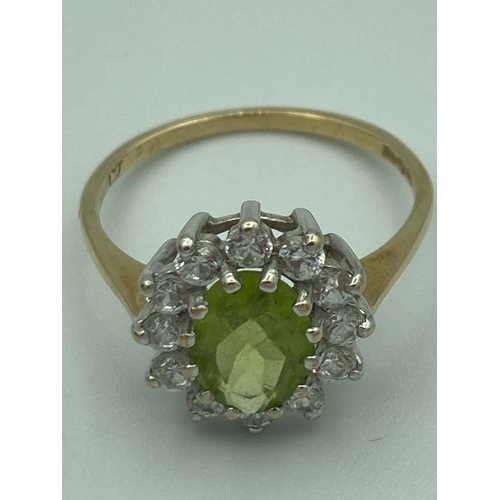 327 - 9 carat GOLD PERIDOT RING with zirconia surround.
 2.0 grams. Size M.