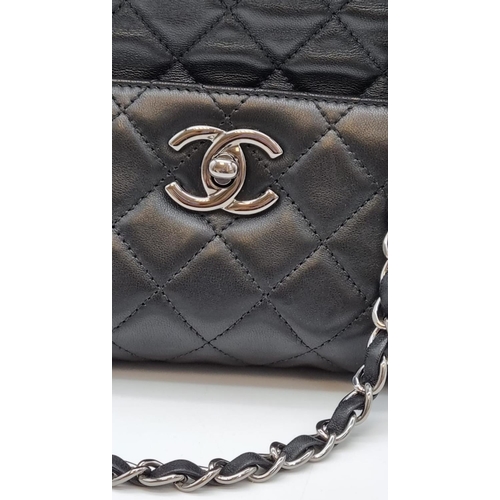 134 - A black caviar leather CHANEL bag. Appr. dimensions: 28 x 11 x 28 cm. with CARTE D'AUTHENTICITE No: ... 