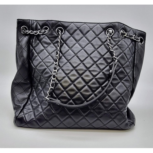 134 - A black caviar leather CHANEL bag. Appr. dimensions: 28 x 11 x 28 cm. with CARTE D'AUTHENTICITE No: ... 