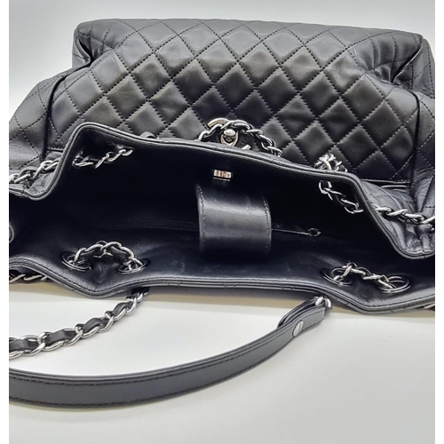 134 - A black caviar leather CHANEL bag. Appr. dimensions: 28 x 11 x 28 cm. with CARTE D'AUTHENTICITE No: ... 